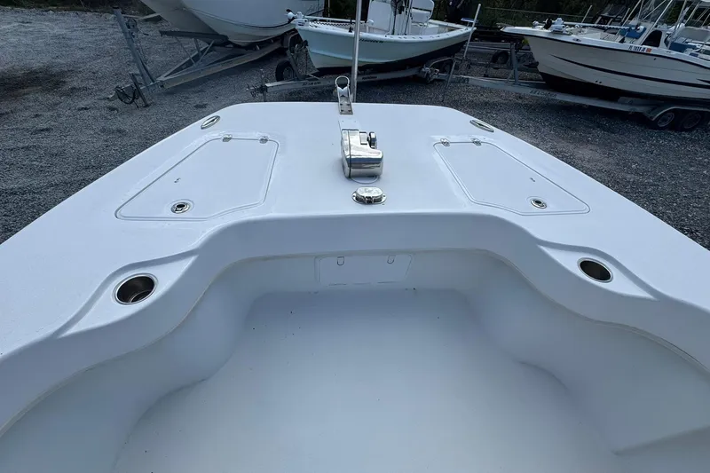 Slide: The Image of 2019 Twin Vee 26 Center Console boat deck with storage compartments and cup holders. - 7