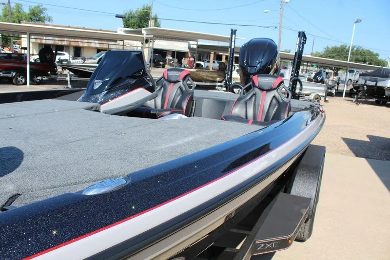 Slide: The Image of 2026 Skeeter ZXE20 boat with sleek design and modern seating at a dealership. - 12