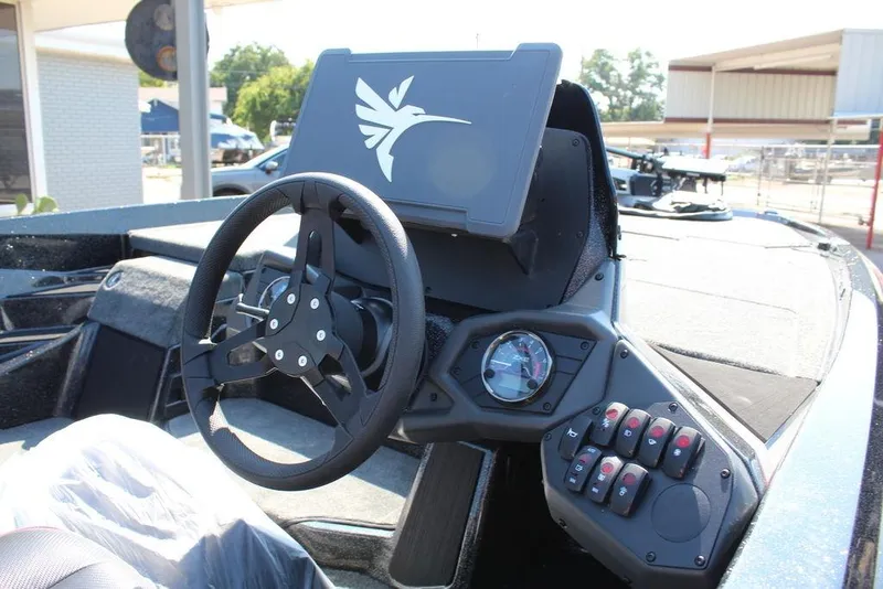 Slide: The Image of 2026 Skeeter ZXE20 boat dashboard with steering wheel and control panel. - 17
