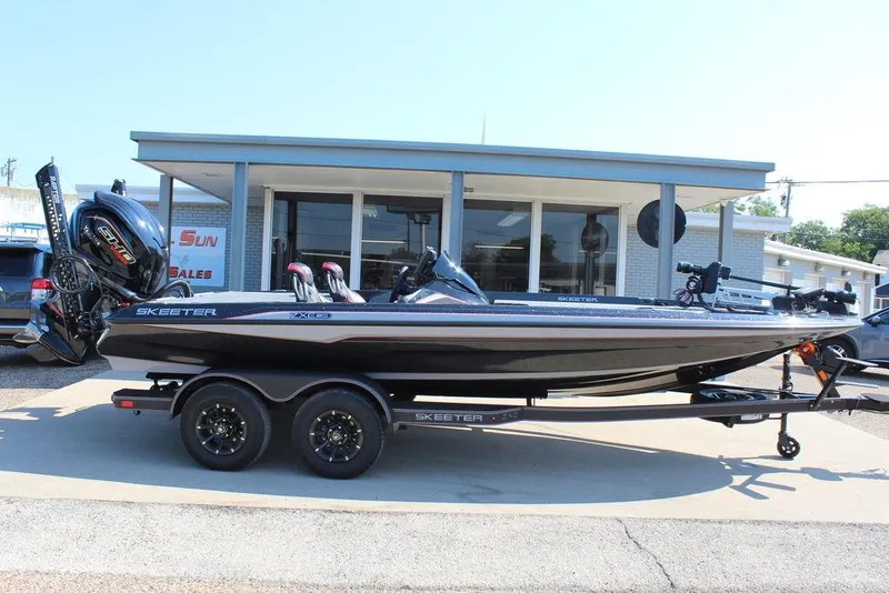 Slide: The Image of 2026 Skeeter ZXE20 boat on trailer outside dealership. - 6