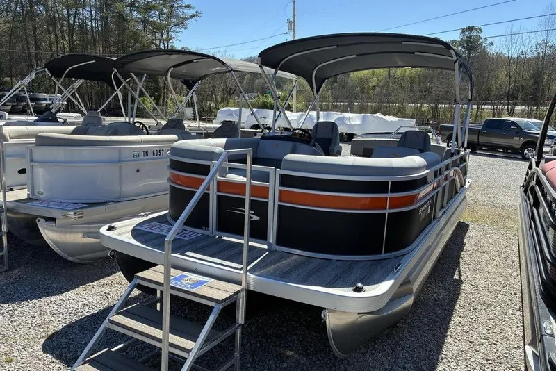 The Image of 2025 Bennington 22 SX Swingback pontoon boat with canopy, displayed outdoors. - 1