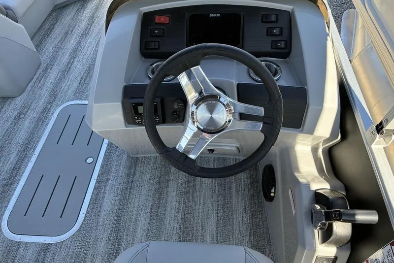 Slide: The Image of 2025 Bennington 22 SX Swingback boat dashboard with steering wheel and controls. - 4
