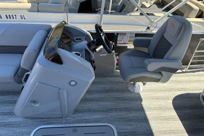 Slide: The Image of 2025 Bennington 22 SX Swingback boat interior with captain's chair and control console. - 7