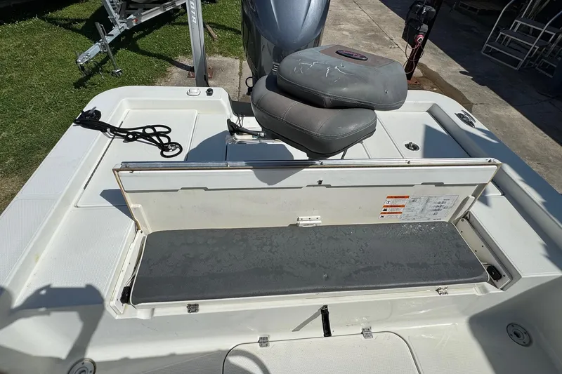 Slide: The Image of 2011 Ranger 2400 Bay Ranger boat interior with open storage compartment and seating. - 14