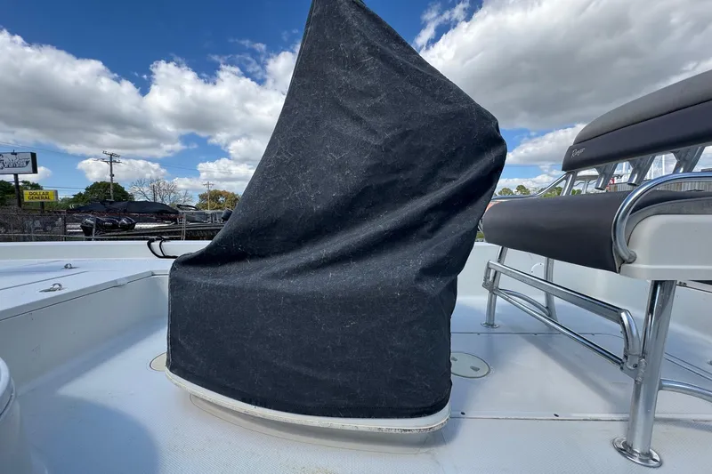 Slide: The Image of 2011 Ranger 2400 Bay Ranger boat with covered console, clear sky background. - 19