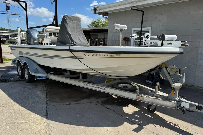 Slide: The Image of 2011 Ranger 2400 Bay Ranger boat on trailer, parked outdoors. - 3