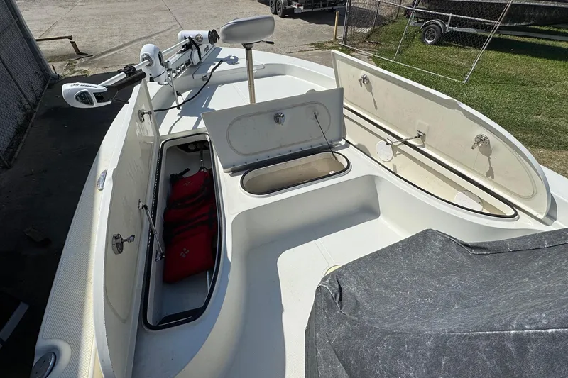 Slide: The Image of 2011 Ranger 2400 Bay Ranger boat interior with open storage compartments. - 8