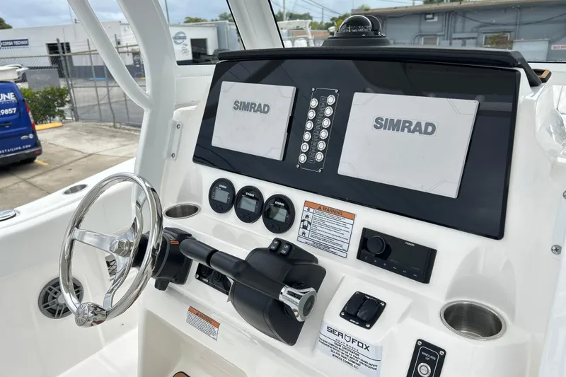 Slide: The Image of 2026 Sea Fox 268 Commander dashboard with dual Simrad displays and steering wheel. - 17