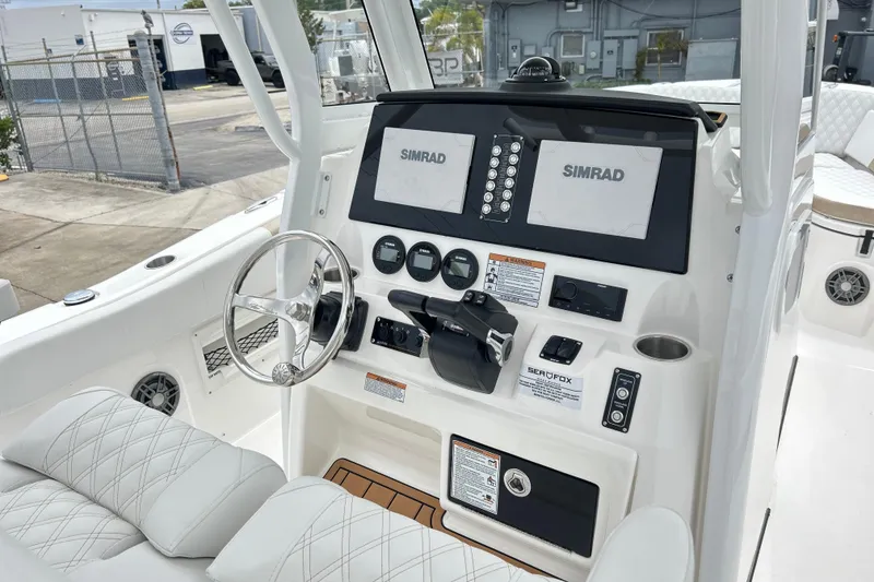 Slide: The Image of 2026 Sea Fox 268 Commander helm with dual Simrad displays and modern controls. - 18