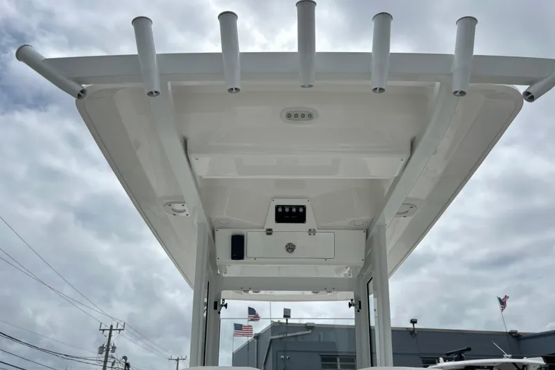 Slide: The Image of 2026 Sea Fox 268 Commander boat roof with rod holders against cloudy sky. - 24