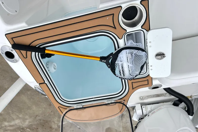 Slide: The Image of 2026 Sea Fox 268 Commander boat deck with storage compartment and fishing net. - 27