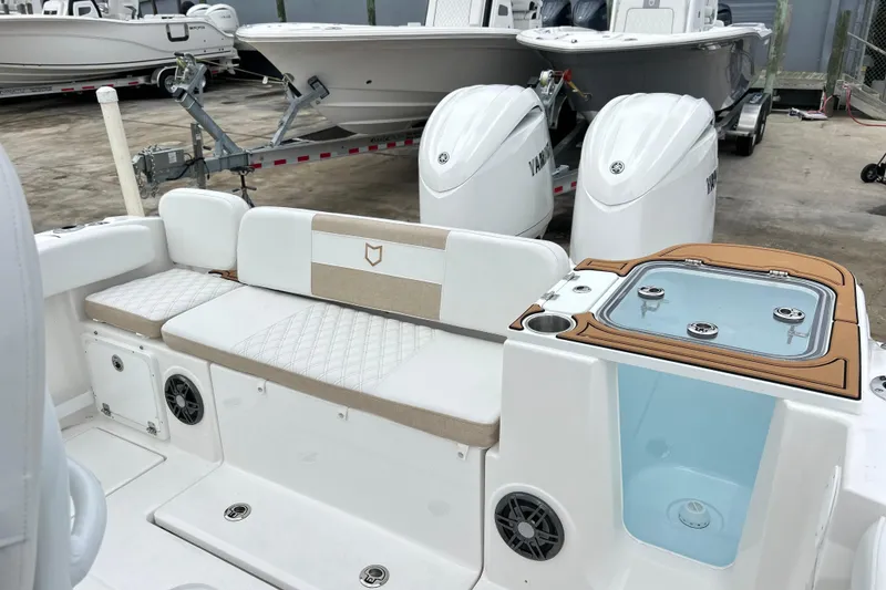 Slide: The Image of 2026 Sea Fox 268 Commander boat interior with seating and livewell, parked with Yamaha engines. - 28
