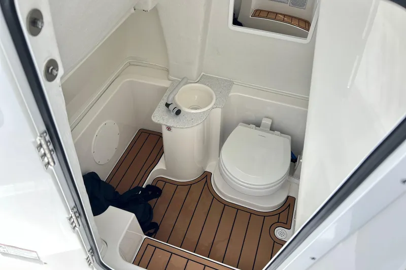 Slide: The Image of 2026 Sea Fox 268 Commander boat bathroom with toilet, sink, and wood-style flooring. - 32