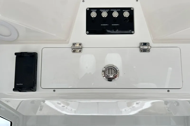 Slide: The Image of Control panel of 2026 Sea Fox 268 Commander boat with switches and storage compartment. - 36