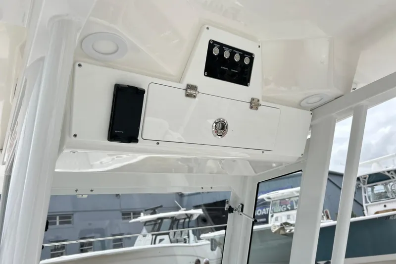 Slide: The Image of 2026 Sea Fox 268 Commander boat console with control panel and storage compartment. - 38