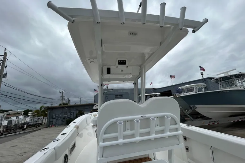 Slide: The Image of 2026 Sea Fox 268 Commander boat with T-top, docked under cloudy skies. - 42