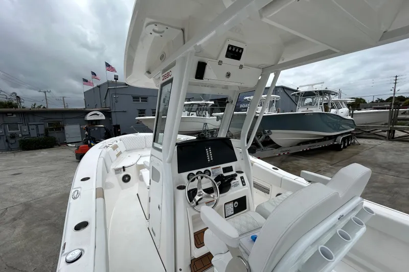 Slide: The Image of 2026 Sea Fox 268 Commander boat interior at a marina with American flags. - 43