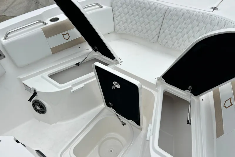 Slide: The Image of 2026 Sea Fox 268 Commander boat interior with open storage compartments and cushioned seating. - 6