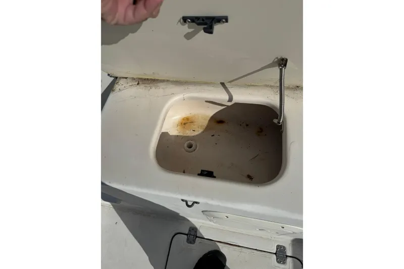 Slide: The Image of Open storage compartment on 2000 Sport-Craft 241 Walk Around boat. - 12