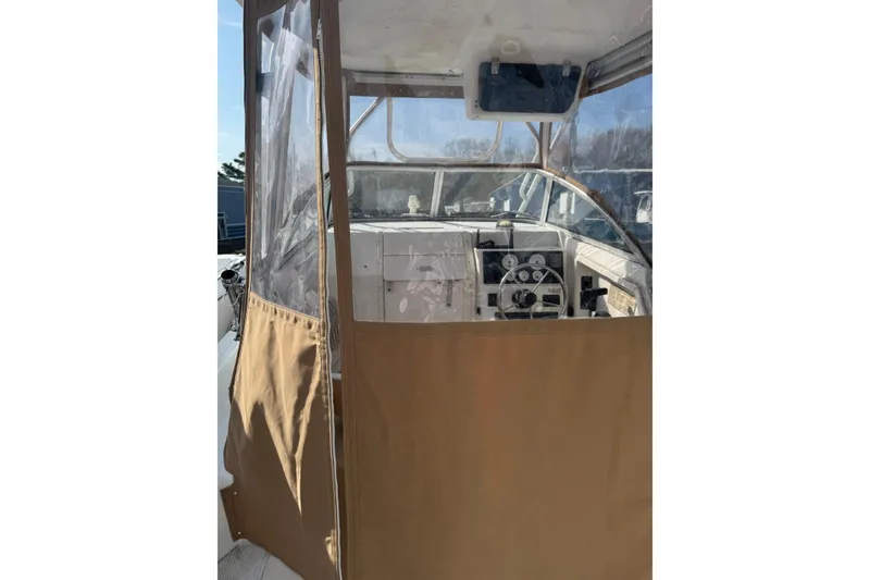 Slide: The Image of 2000 Sport-Craft 241 Walk Around boat interior with protective canvas enclosure. - 13