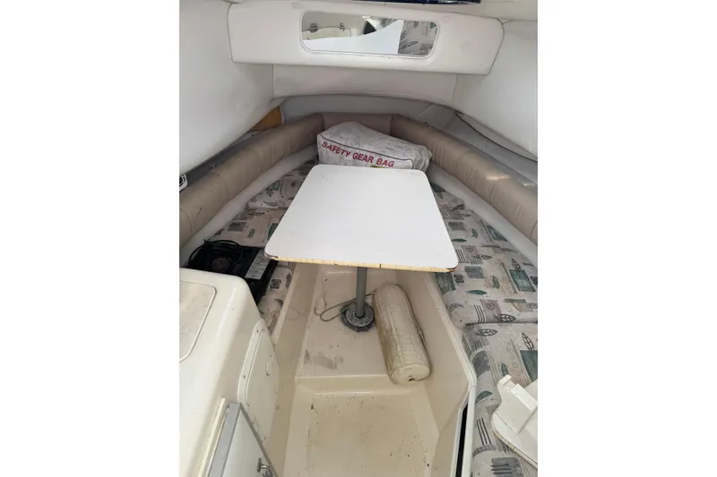 Slide: The Image of Interior cabin of 2000 Sport-Craft 241 Walk Around boat with table and seating. - 16