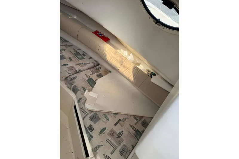 Slide: The Image of Interior cabin of 2000 Sport-Craft 241 Walk Around boat with patterned cushions. - 17