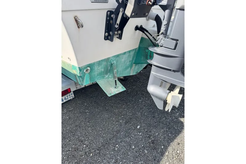 Slide: The Image of Rear view of a 2000 Sport-Craft 241 Walk Around boat with visible outboard motor. - 9