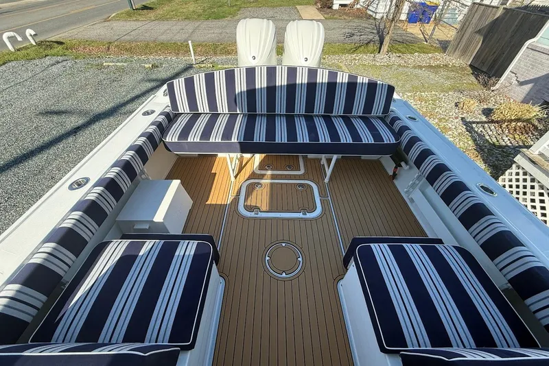 Slide: The Image of Steiger Craft 28 Annapolis 2026 with striped seating cushions. - 10