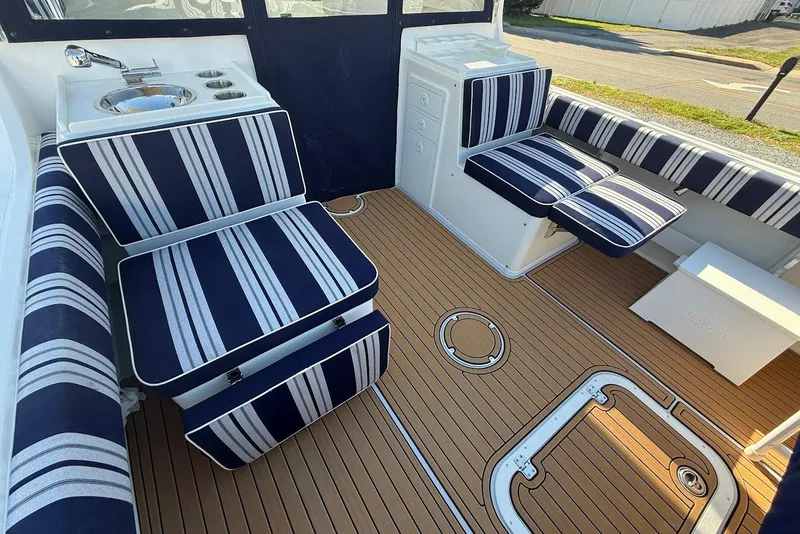 Slide: The Image of Interior of 2026 Steiger Craft 28 Annapolis with striped upholstery. - 11