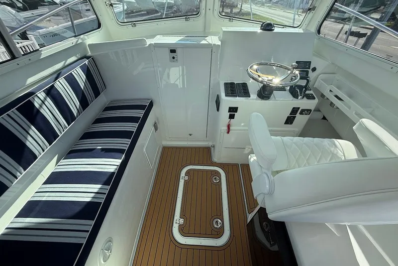 Slide: The Image of Interior of 2026 Steiger Craft 28 Annapolis with seating and helm station. - 15