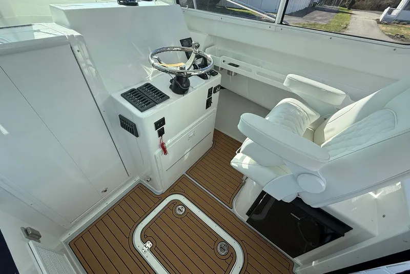 Slide: The Image of Interior of 2026 Steiger Craft 28 Annapolis with helm and seating. - 17