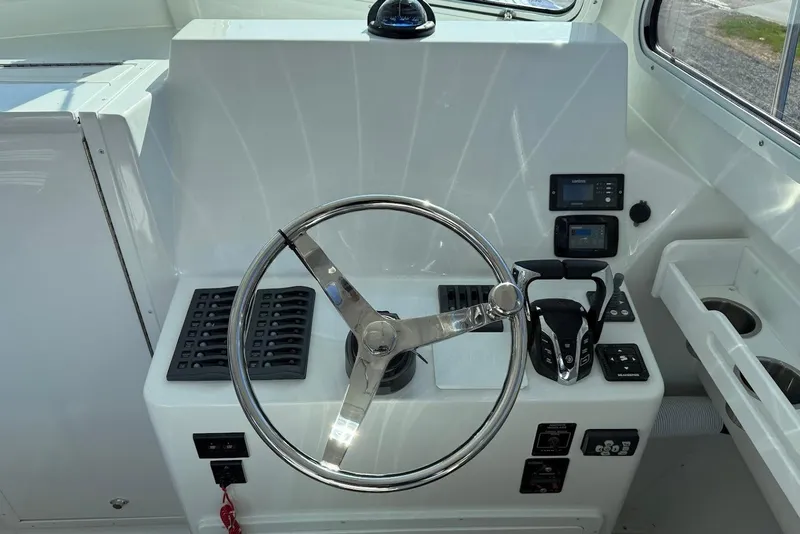 Slide: The Image of Steiger Craft 28 Annapolis 2026 helm with modern controls. - 19