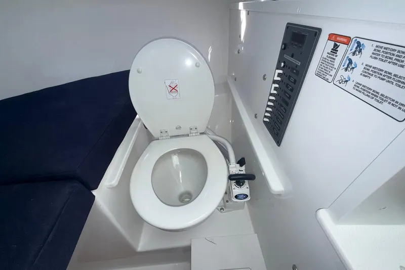Slide: The Image of Interior of 2026 Steiger Craft 28 Annapolis with toilet and control panel. - 21