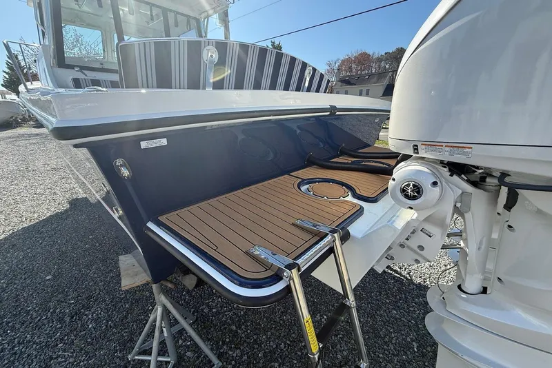 Slide: The Image of Steiger Craft 28 Annapolis 2026 with outboard motor and teak deck. - 8