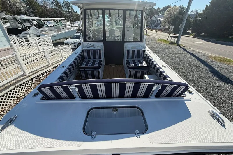 Slide: The Image of 2026 Steiger Craft 28 Annapolis with striped outdoor seating. - 9