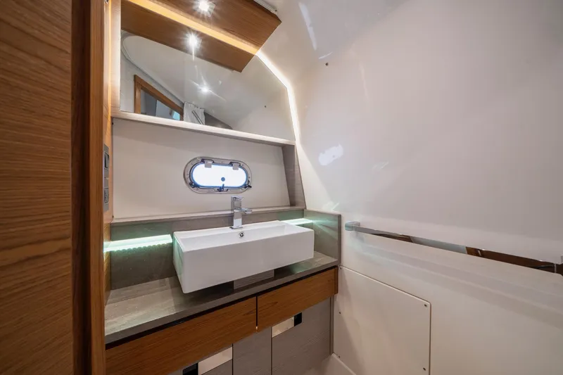 Slide: The Image of Luxurious bathroom interior of 2024 Tiara Yachts 43 LS, featuring modern sink and elegant wood accents. - 10