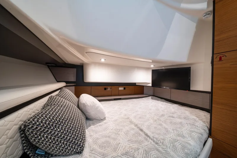 Slide: The Image of Luxurious interior cabin of 2024 Tiara Yachts 43 LS with modern bedding and TV. - 12