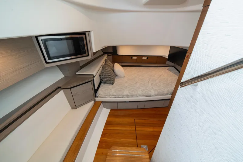 Slide: The Image of Luxurious interior of 2024 Tiara Yachts 43 LS, featuring a cozy bed and modern amenities. - 14