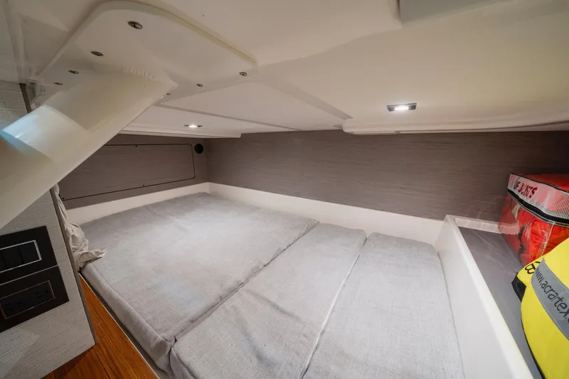 Slide: The Image of 2024 Tiara Yachts 43 LS cabin interior with cozy bed and modern lighting. - 15