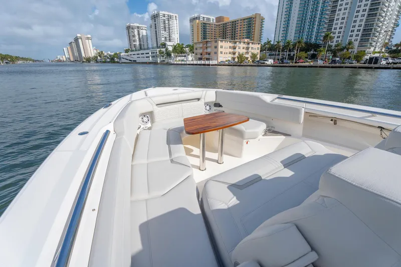 Slide: The Image of Luxurious 2024 Tiara Yachts 43 LS with elegant seating and scenic waterfront view. - 16