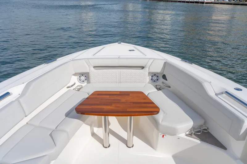 Slide: The Image of Luxurious seating area on 2024 Tiara Yachts 43 LS, featuring elegant wood table. - 17