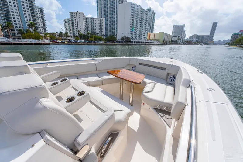 Slide: The Image of Luxurious 2024 Tiara Yachts 43 LS with elegant seating and scenic waterfront view. - 19