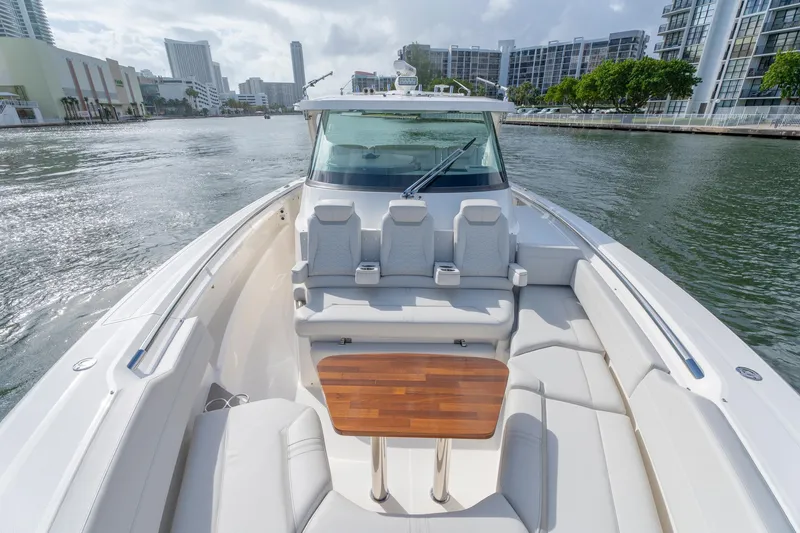 Slide: The Image of 2024 Tiara Yachts 43 LS luxury boat with spacious seating and wooden table on water. - 20