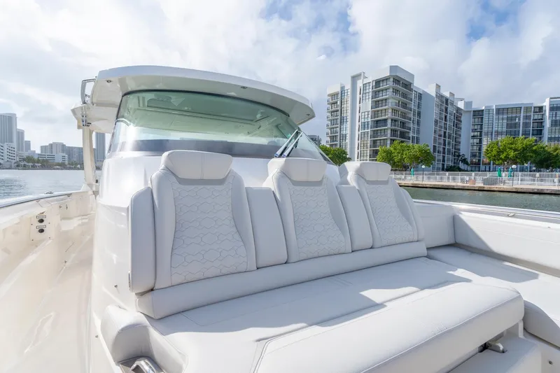 Slide: The Image of 2024 Tiara Yachts 43 LS luxury seating with waterfront cityscape backdrop. - 21