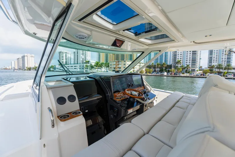 Slide: The Image of Luxurious 2024 Tiara Yachts 43 LS interior with modern dashboard and waterfront view. - 23