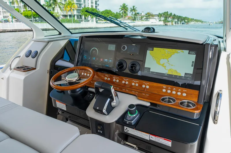 Slide: The Image of 2024 Tiara Yachts 43 LS helm with advanced navigation displays and luxurious wood accents. - 26