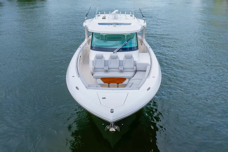 Slide: The Image of 2024 Tiara Yachts 43 LS luxury boat on calm water, front view. - 3