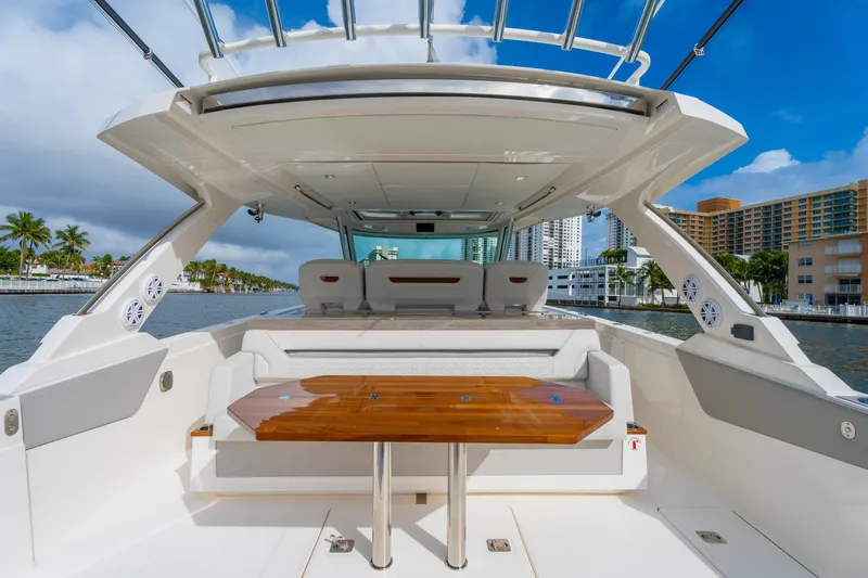 Slide: The Image of 2024 Tiara Yachts 43 LS luxury yacht interior with elegant seating and wooden table. - 38