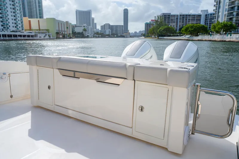 Slide: The Image of 2024 Tiara Yachts 43 LS boat with dual engines, docked in a city marina. - 43