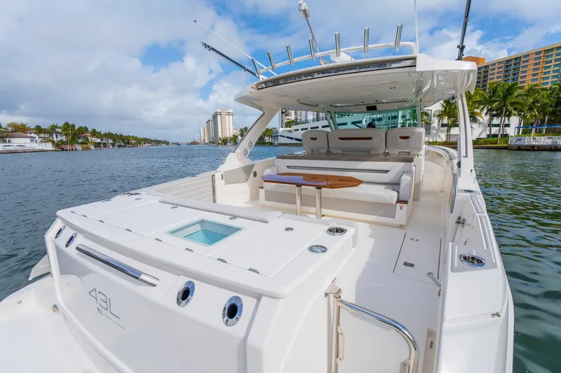 Slide: The Image of 2024 Tiara Yachts 43 LS luxury boat on a scenic waterway. - 46